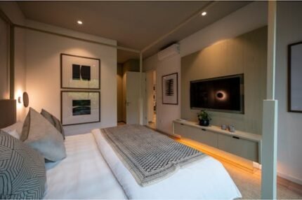 Inviting modern bedroom interior with minimalist decor, stylish furniture, and warm lighting.