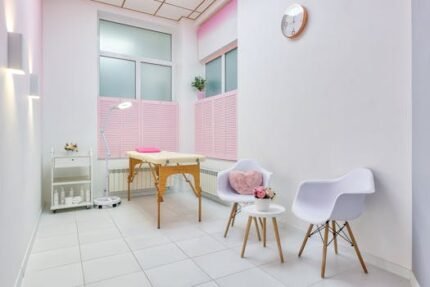 Interior of beauty salon with table for spa procedures and set of skincare products and flower decorations